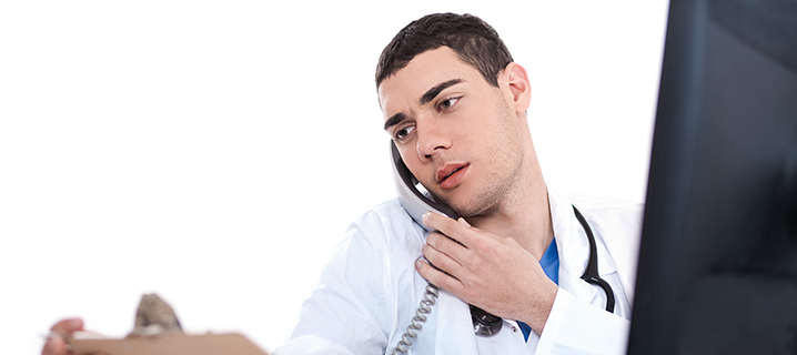 Young doctor on phone stock